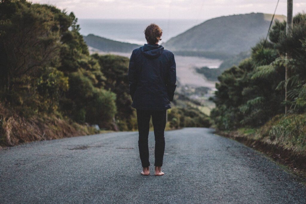 Man standing on road in New Zealand