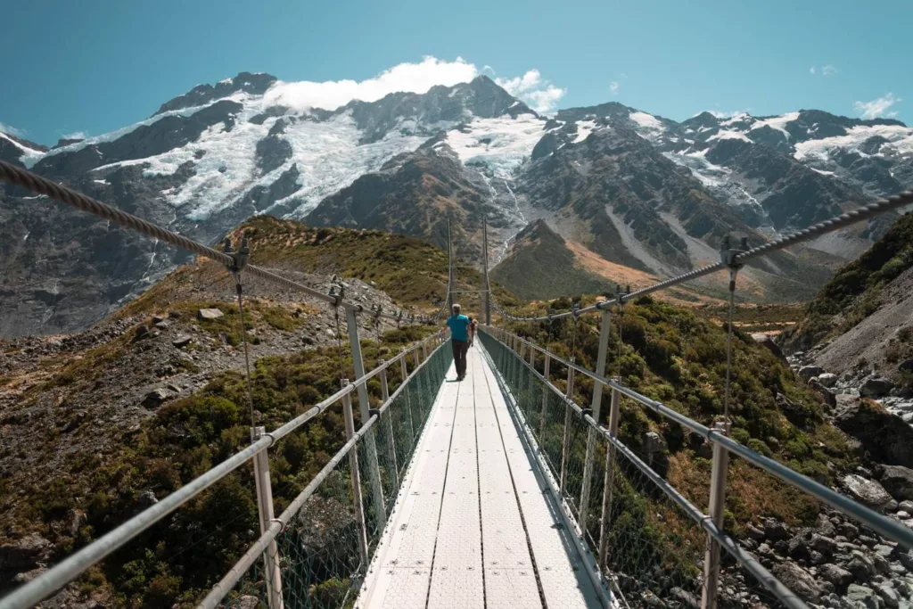 Man on bridge with hooker glacier in background