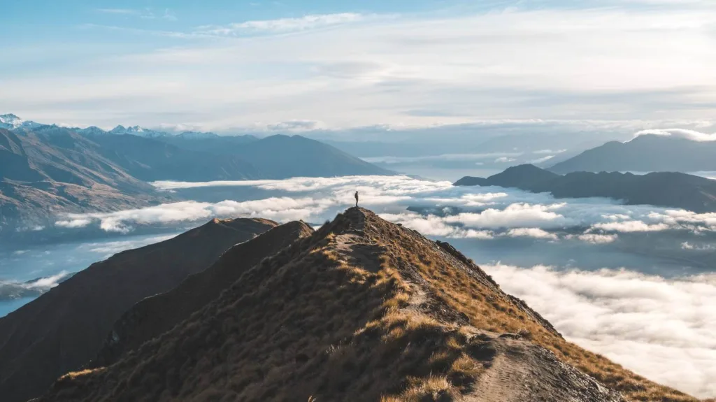 Person standing on top of roy's peak